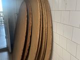 a stack of wooden plates on the floor in a bathroom