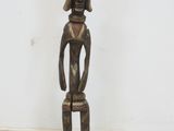 an image of a wooden statue of a man with a hat on his head