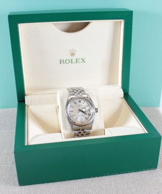 a close up of a watch in a box on a table