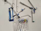 several toothbrushes are lined up on a white surface