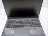 a laptop that is open on a white surface