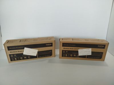 pair of two boxes sitting on top of a white table