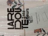 a picture of a folded sheet with a label on it