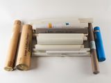 many rolls of paper and pens on the table