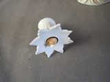 a small figurine of a baby in a shell on a table