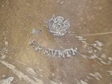 a close up of a silver plate with a crown on it