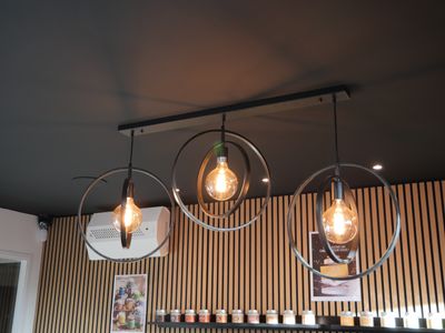 three light bulbs hanging from the ceiling of a restaurant