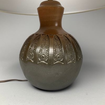 a lamp that is on a table next to a lamp shade