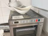 a microwave with a bowl on top of it in a kitchen