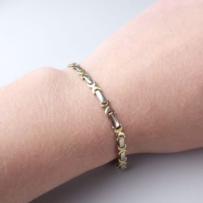 a close up of a person ' s arm with a bracelet on it