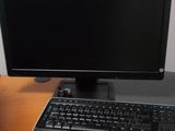 a desk with a computer, keyboard and mouse on it
