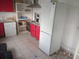 a kitchen with a refrigerator, stove, microwave, and a refrigerator freezer