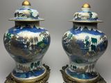 pair of blue and white vases with gold accents on stands