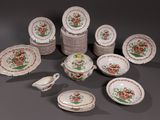 many plates and bowls and spoons that are on the table
