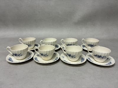 six cups and saucers with blue flowers on them on a table