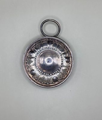 an antique silver plate with a circular design on it