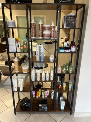 a shelf with many different types of hair products on it