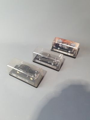 three miniature cars that are sitting on a table
