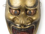 une image représentant un masque doré aux yeux rouges sur fond blanc
