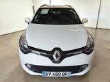 the front view of a white car parked in a garage