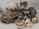 a lot of silverware and silverware on a table