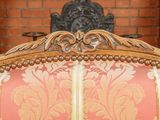 a red and white couch with a red and gold pattern