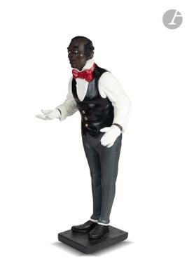 figurine représentant un homme en smoking avec un nœud papillon rouge