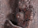 a statue of a man holding a baby on a door