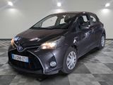 the toyota yaris is parked in a large room with a checkered floor