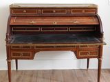 an antique writing desk with a marble top and brass accents