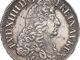a silver coin with a crown on top of it