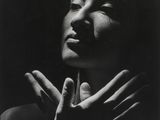 a black and white photo of a woman holding her hands together