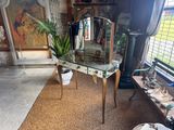 a glass table with a mirror on it in a room
