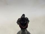 a black and white vase with a bird on top of it