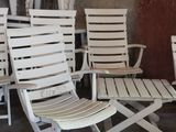 many white chairs and a table in a room