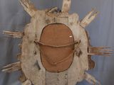 a wooden sculpture of a sunburst on a stand