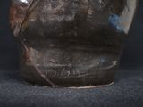 a close up of a vase on a black surface