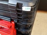 a black case with a red handle on the floor