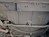 the underside of a vehicle with a car underneath it