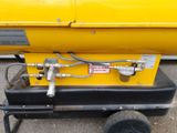 a yellow machine with a hose attached to it