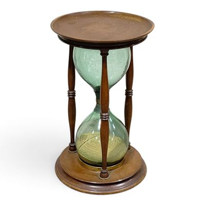 wooden and glass hourglass on stand on white background