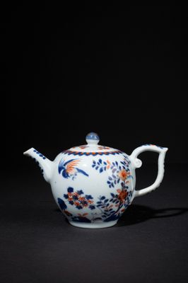 a blue and white teapot with a floral design on it