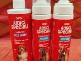 three bottles of dog sham sitting on a bed next to each other