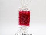a bag of candy sitting on top of a black stand