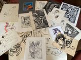a lot of drawings on a table with a laptop