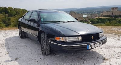 a black car that is parked on the side of the road