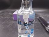 a bottle of liquid sitting on a table next to a pair of scissors
