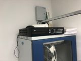 a television sitting on top of a blue cabinet in a room