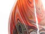 brightly colored glass vase sitting on top of a wooden table
