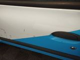a blue and white car door with a black handle